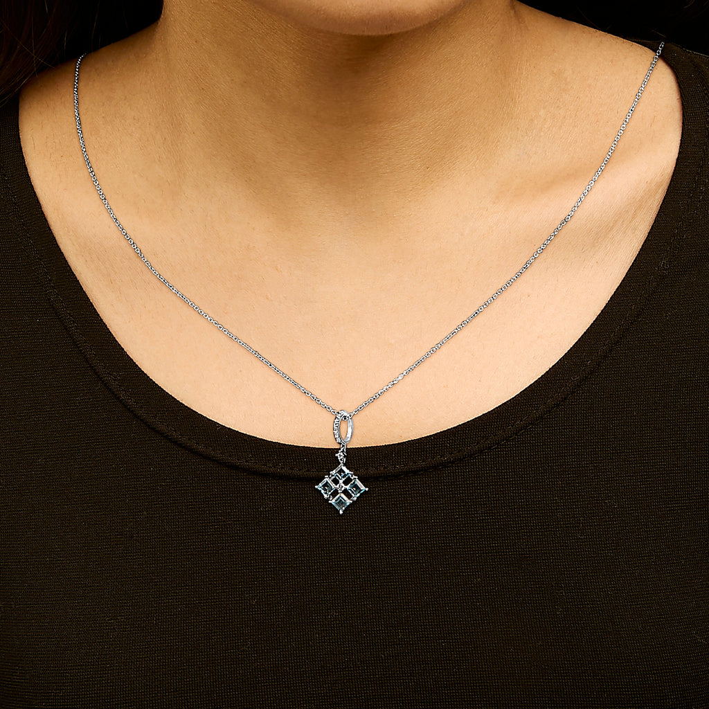 Blue topaz pendant necklace worn by model