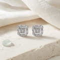 Sterling silver diamond knot earrings styled on pale stone