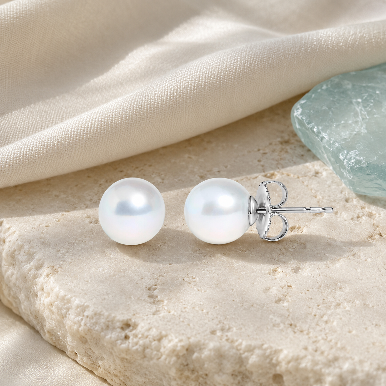 Freshwater pearl stud earrings styled with ivory linen and sea glass