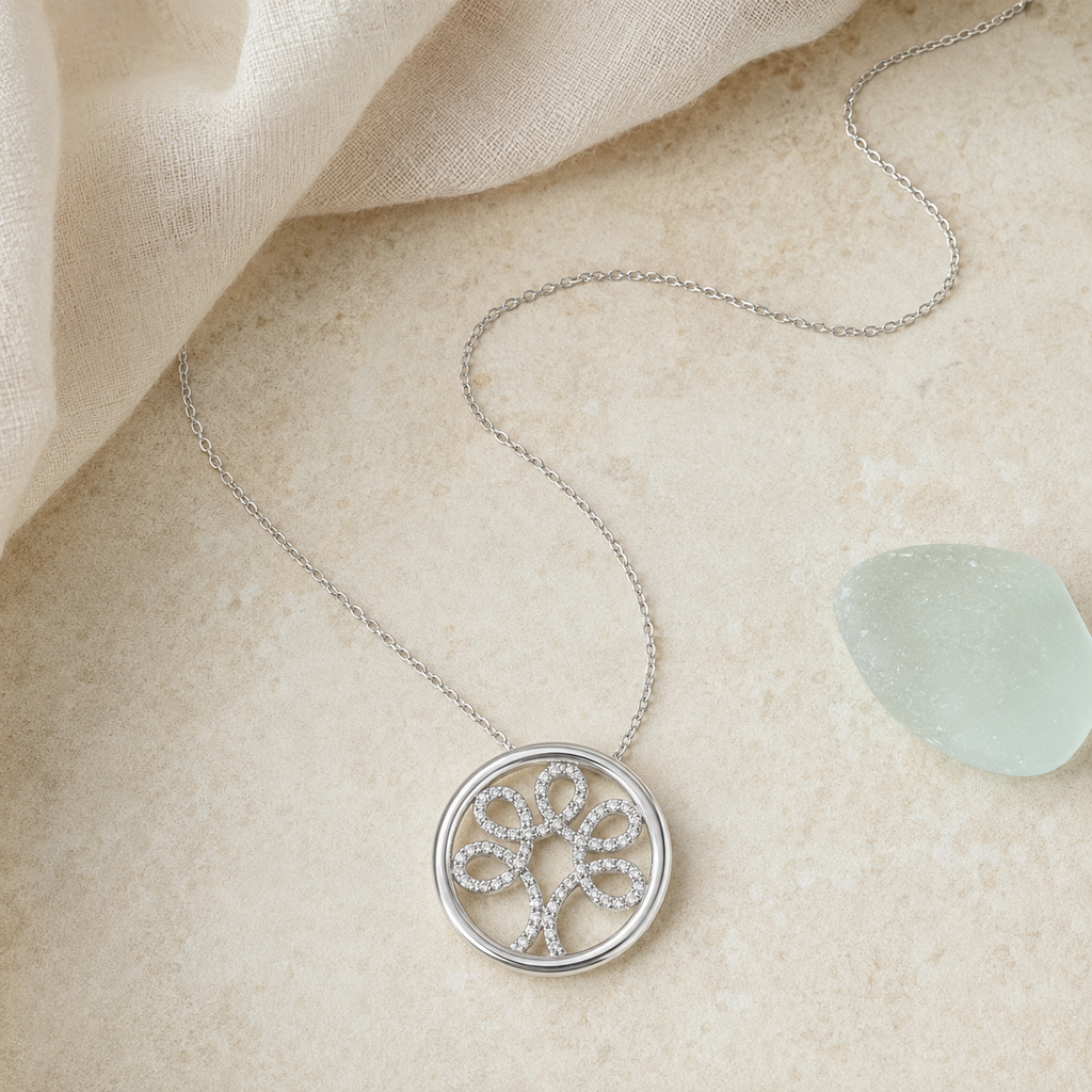 Sterling silver diamond Tree of Life necklace styled on pale stone